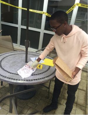Dylan ('17) collects and analyzes evidence at a mock crime scene as part of the Honors Forensics class.