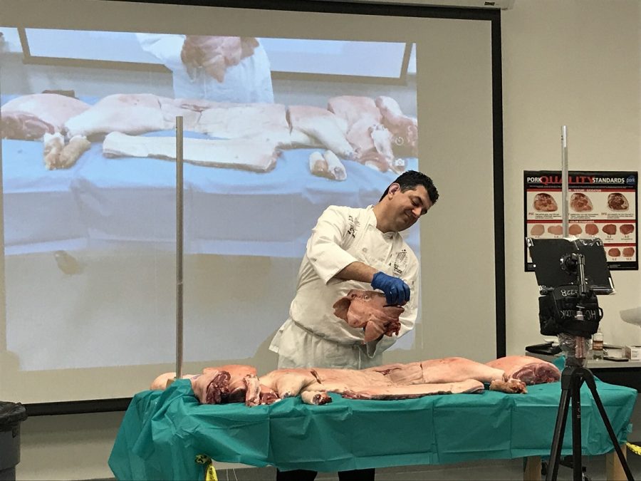 Cooking instructors come to Hillcrest High School to explain the pork preparation process to students. 
