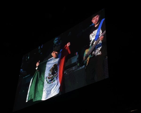 Junior H holding Mexican Flag